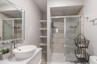a white bathroom with a shower and a sink at Comfort Tenacity in Yellowknife