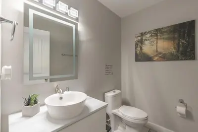 a white bathroom with a sink and a toilet at Comfort Tenacity in Yellowknife