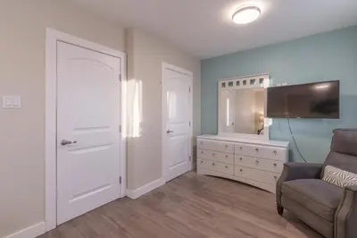 a living room with a couch and a flat screen tv at Comfort Tenacity in Yellowknife
