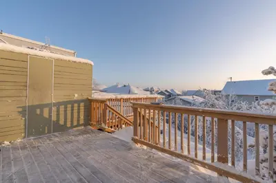 a wooden deck with snow on the ground at Comfort Tenacity in Yellowknife