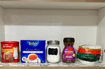 a shelf with various food items on it at Sleek Guest Retreat SW EDM BSMT Suite in Edmonton