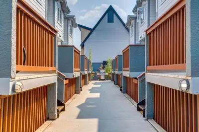 a row of colorful houses on a street at Stunning 3BR Escape with Mountain Views in Canmore in Canmore
