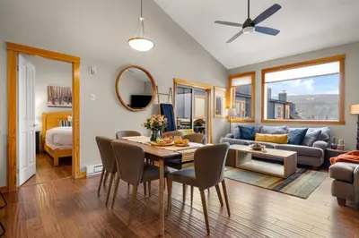 a living room with a table and a couch at 3BR Luxury Top Floor Condo with Great views in Canmore