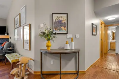 a living room with a table and a chair at 3BR Luxury Top Floor Condo with Great views in Canmore