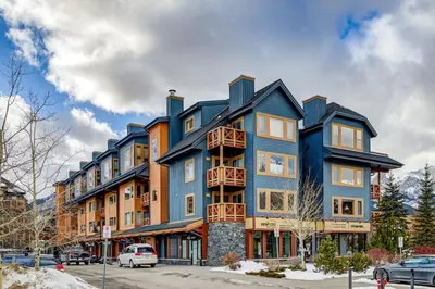 a large blue building on a city street at Spacious 3 BR Condo with Gym and Hot tub in Canmore