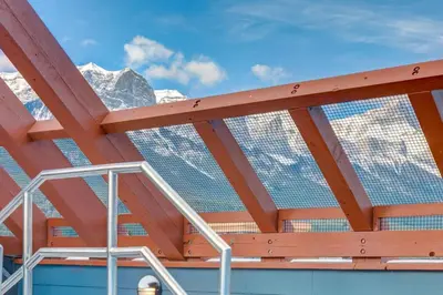 a roof of a building with mountains in the background at Spacious 3 BR Condo with Gym and Hot tub in Canmore