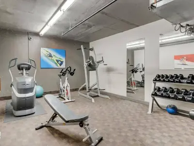 a gym with several exercise equipment in a room at Comfy 2BR Minutes from Downtown with Hot Tub in Dead Man's Flats
