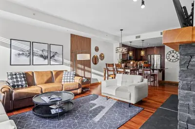 a living room with a couch and a table at Mountain Views Lux 2BR Condo in Canmore with Hot Tub in Canmore