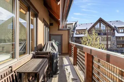 a balcony with a bench and a window at Mountain Views Lux 2BR Condo in Canmore with Hot Tub in Canmore