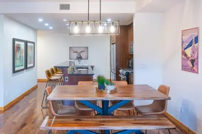 a dining room and kitchen with a wooden table and chairs at Serene 3BR Rockies Stay with Hot Tub and Near DT in Canmore