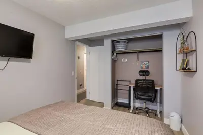 a bedroom with a bed and a desk at Casablanca - 3 BR Family & Game Haven in Calgary