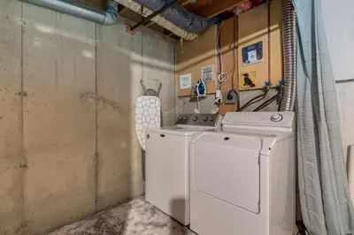 a laundry room with a dryer and a washer at Casablanca - 3 BR Family & Game Haven in Calgary