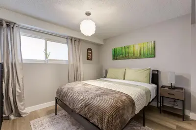 a bedroom with a bed and a window at Casablanca - 3 BR Family & Game Haven in Calgary