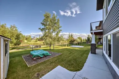 a view of a yard with a table in the grass at Waterfront Home, Fireplace, 90 min to Banff in Airdrie