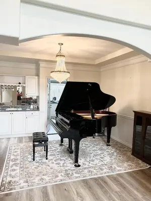a black piano in a room with a kitchen at Two Bedrooms One King Bed and One Double Bed in Richmond