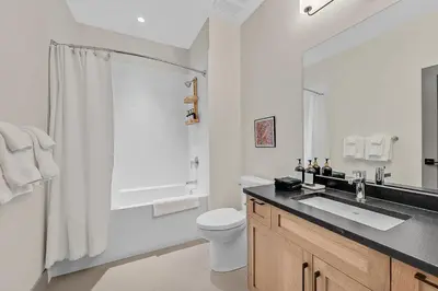 a bathroom with a toilet and a sink and a shower at Western Star Chalet Ski in out and Amazing Mtn View in Big White