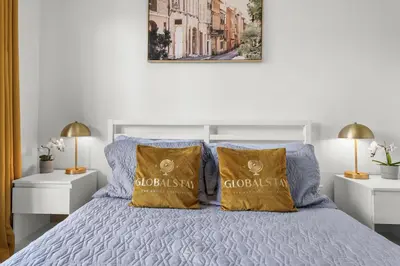 a white bedroom with a bed with two yellow pillows at GlobalStay Cozy 1 Bedroom Condo with Balcony Downtown Calgary in Calgary