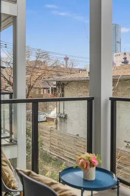 a balcony with a table and a view of a building at GlobalStay Cozy 1 Bedroom Condo with Balcony Downtown Calgary in Calgary