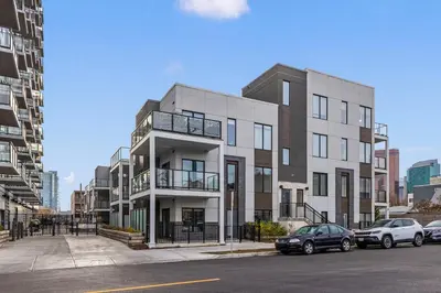 a large white building with cars parked in front of it at GlobalStay Cozy 1 Bedroom Condo with Balcony Downtown Calgary in Calgary