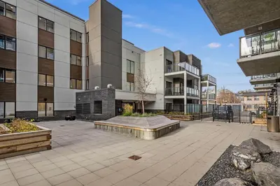 a large building with a fireplace in a courtyard at GlobalStay Cozy 1 Bedroom Condo with Balcony Downtown Calgary in Calgary