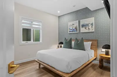 a bedroom with a large white bed and a window at Sisters' Solstice Villa by WeekAway Vacations in Canmore