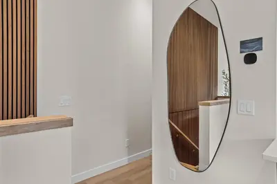 a mirror hanging on a wall in a room at Sisters' Solstice Villa by WeekAway Vacations in Canmore