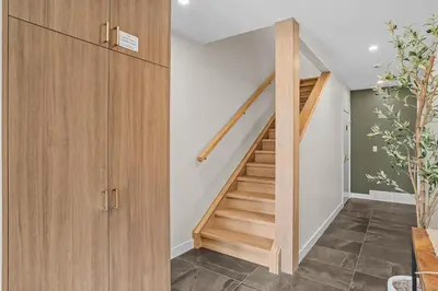 a staircase in a home with wooden cabinets at Sisters' Solstice Villa by WeekAway Vacations in Canmore