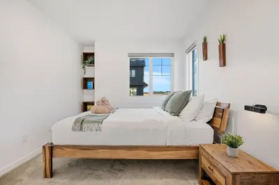 a bedroom with a large bed and a window at Luxury Family Retreat with Games, King Bed and Garage in Edmonton