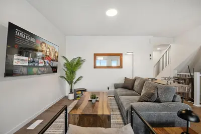 a living room with a couch and a table at Single Detached Full House with Ping Pong King Bed and Garage in Edmonton