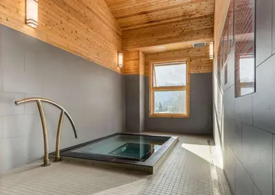 a hot tub in a room with a wooden ceiling at Cloud Nine - Stunning Views Rooftop Hot Tub in Canmore