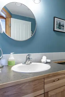 a bathroom with a sink and a mirror at Cloud Nine - Stunning Views Rooftop Hot Tub in Canmore