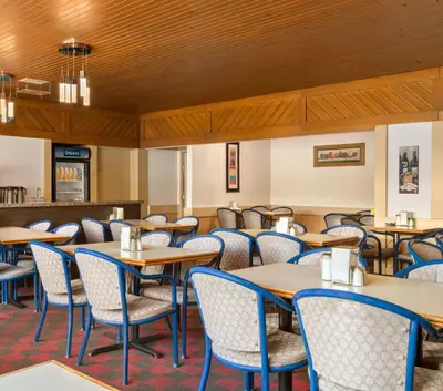 a dining room with tables and chairs at Canada Grey Motor Inn in Hanna