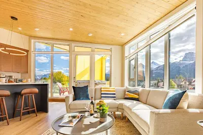 a living room with a couch and a table at Ravens Peak - Private Hot Tub in Canmore
