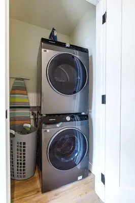 a washer and a washing machine in a room at Ravens Peak - Private Hot Tub in Canmore