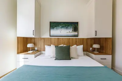 a bedroom with a large bed with white and blue at Ravens Peak - Private Hot Tub in Canmore