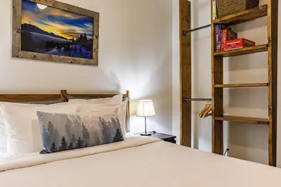 a bedroom with a bed and a book shelf at Valhalla - Pure Mountain Bliss in Canmore