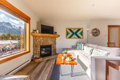 a living room with a couch and a fireplace at Valhalla - Pure Mountain Bliss in Canmore