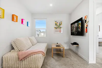 a living room with a couch and a table at Luxe Retreat with Gym, Ping Pong, King Bed, Near WEM in Edmonton