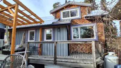 a tiny house with a roof on a deck at Yukon Sweet Spot Bed and Bakery in Whitehorse