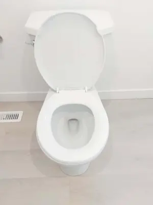 a white toilet with the lid open in a bathroom at 43 Erin Woods Drive SE Calgary in Calgary