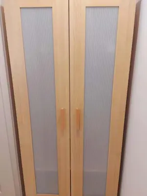 a wooden cabinet with two glass doors on a wall at 43 Erin Woods Drive SE Calgary in Calgary
