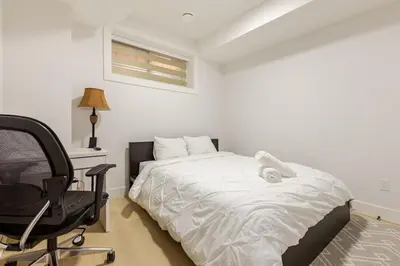 a bedroom with a bed and a desk and a chair at Cozy, Classy 2 BedRM Private Suite with Netflix and Parking in Edmonton