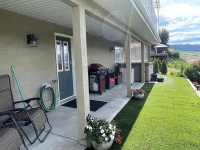 a front porch of a house with a blue door at 20 KLM from SilverStar with private Hot Tub in Vernon