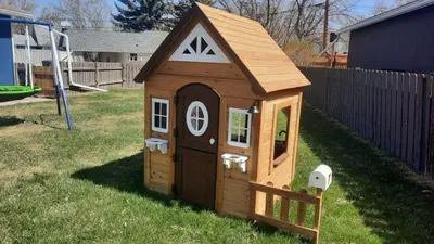 a small wooden dog house in a yard at Blue Raptor Family-Friendly 3BR Private Yard in Drumheller