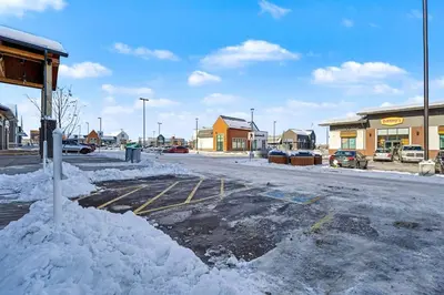 a parking lot with snow on the side of a street at Deluxe 2-Bedroom Getaway Near Mahogany Lake in Calgary