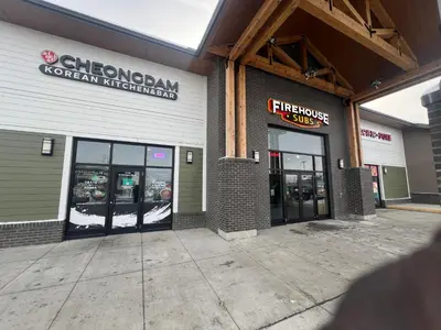a store front with doors open in a building at Deluxe 2-Bedroom Getaway Near Mahogany Lake in Calgary