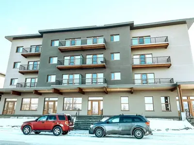 two cars parked in front of a building at Golden Moments in Golden
