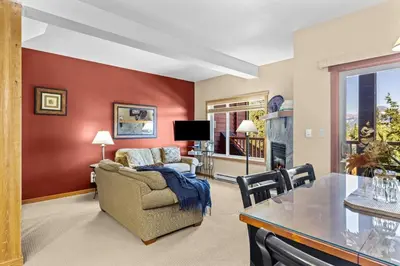 a living room with a couch and a table at Whispering Pines 3BR Townhouse Views and private Hot Tub in Golden