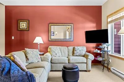 a living room with a couch and a tv at Whispering Pines 3BR Townhouse Views and private Hot Tub in Golden