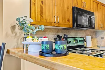 a kitchen counter with two coffee cups on it at Whispering Pines 3BR Townhouse Views and private Hot Tub in Golden
